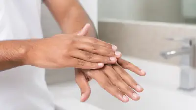 Applying Moisturizing Cream to Hands Post Wash - Dermatology Stock Photo