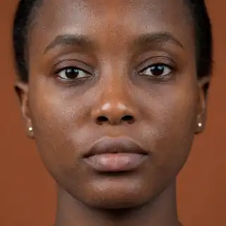 Healthy Young Black Woman Face Close Up - Medical Dermatology Stock Photo