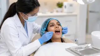 Female Dentist Performing Routine Dental Examination on Patient
