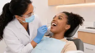 Preventive Dental Checkup with Dentist Examining Patient Teeth Stock Photo