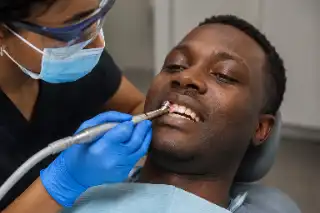Dental Polishing Session Performed by Dentist on Patient Teeth