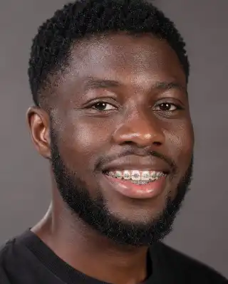 Young Adult Male Patient With Metal Dental Braces Smiling
