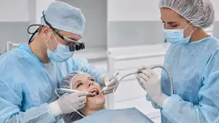 Dental Surgeons Performing Single Implant Surgery in Clinic Stock Photo