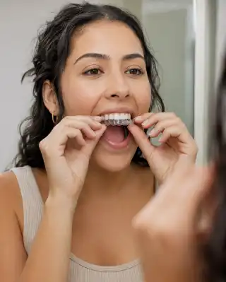 Young Woman Inserting Transparent Aligner Braces - Orthodontic Dental Care