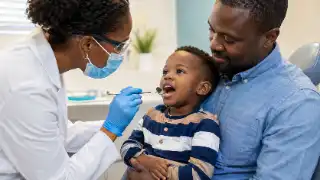Child's First Dental Visit with Pediatric Dentist and Father