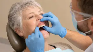 Dentist Fitting Complete Denture For Elderly Female Patient - Dental Care Photo